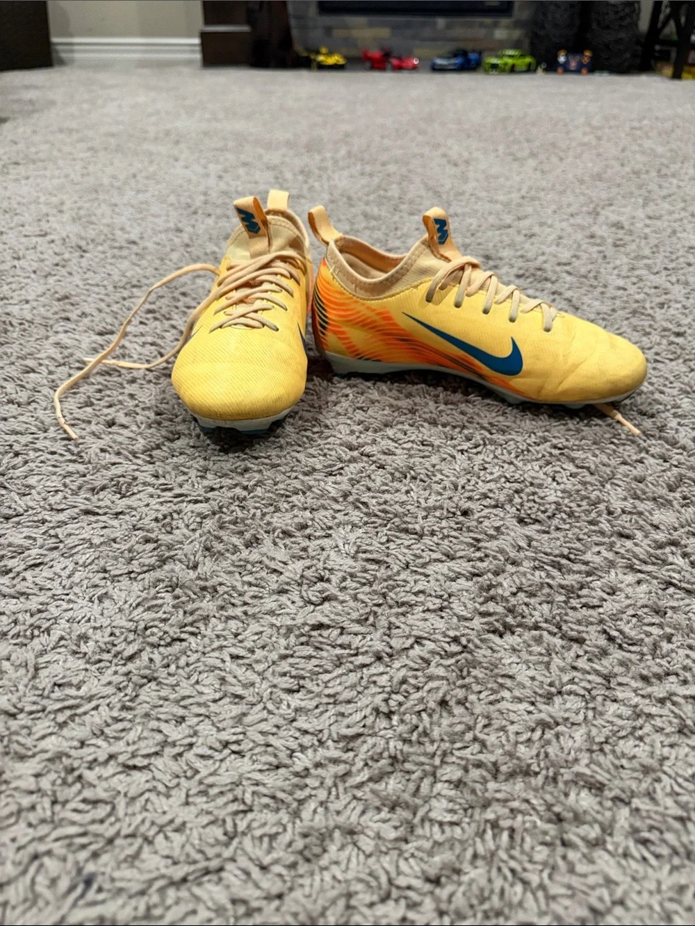 Nike Yellow Soccer Cleats with Blue Swoosh and Orange Accents